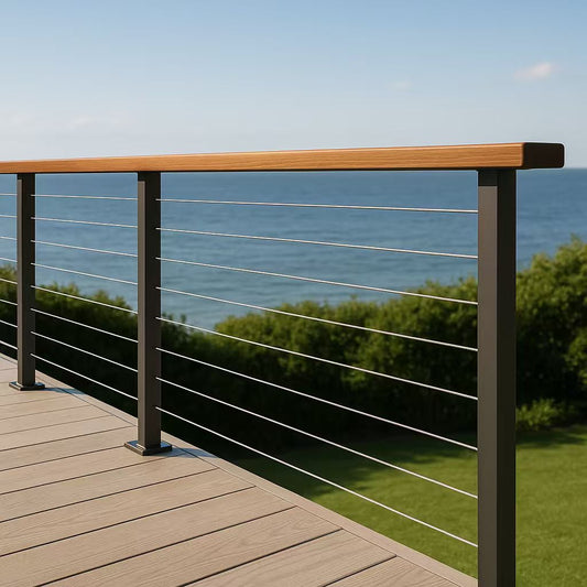 Modern outdoor deck with sleek cable railing and wooden handrail overlooking a scenic ocean view.