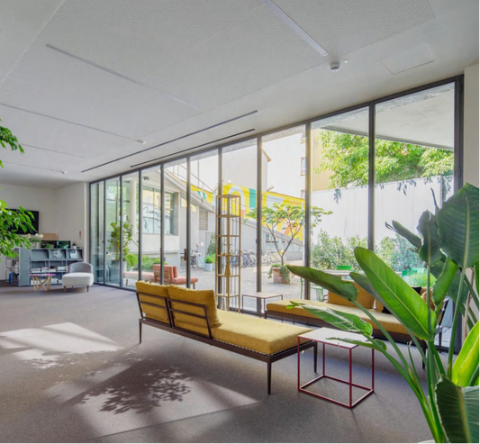 Black-framed multi-panel folding glass door installed between an interior room and outdoor space.