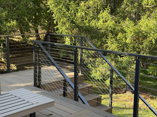 Black cable railing on composite deck stairs