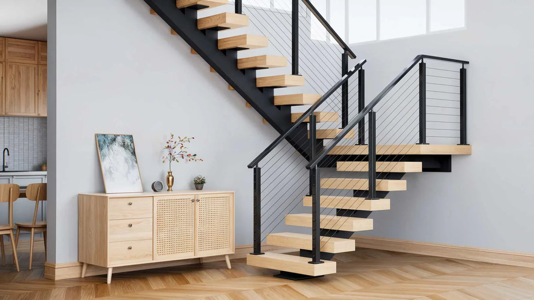Modern floating stairs with wooden steps and black metal railings in a bright living space next to a wooden sideboard and kitchen area.