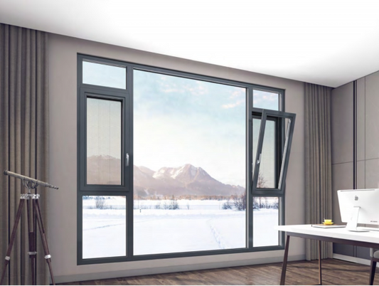 Dark aluminum window wall with tilt-turn vents in a bright home office