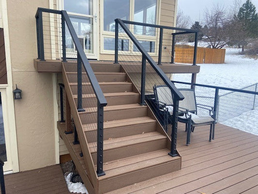 Finished outdoor deck with cable railing and wood stairs