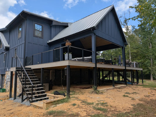 Customer photo of black cable railing around a covered elevated deck with an exterior staircase.
