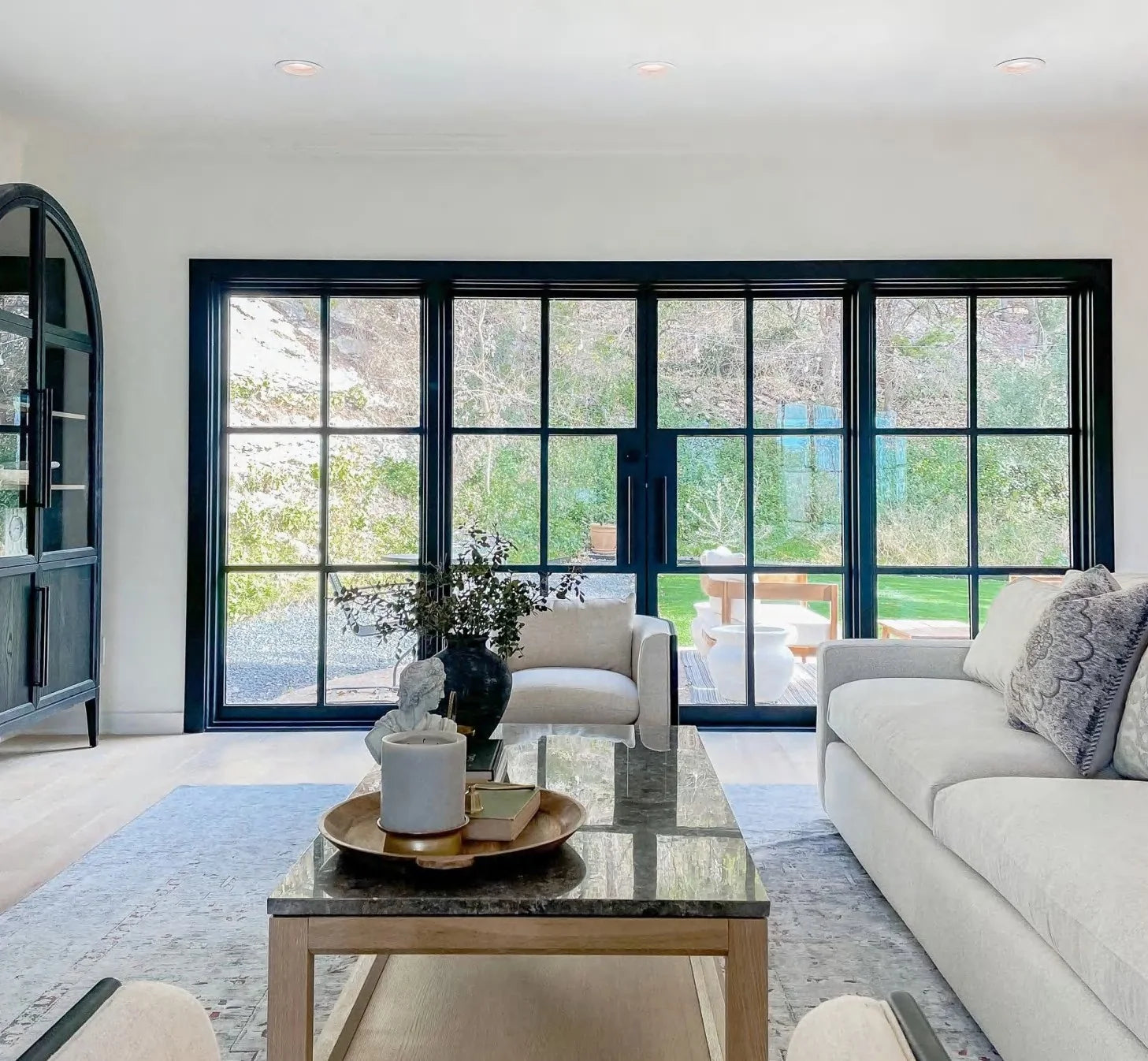 Bright living room with black slim steel windows